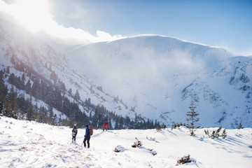 Fototapeta na wymiar Extreme men climb the mountain for downhill skiing in Carpathian