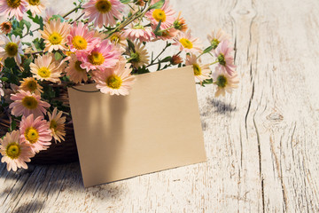 Card for text near the basket with flowers of chrysanthemum