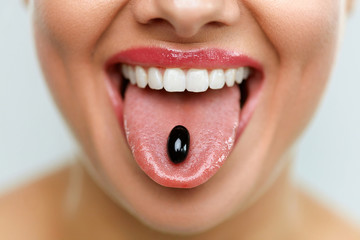 Beautiful Woman Mouth With Pill On Tongue. Girl Taking Medicine