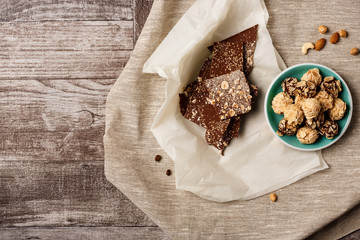 Chocolate and nuts over wooden backgrpound. Above.