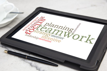 tablet with teamwork word cloud