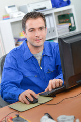 Manual worker at his computer