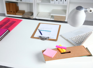 Stack of books and stationery isolated on white background