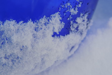 синяя стеклянная ваза в снегу