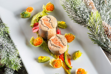 fish starter food on white plate with christmas decoration. product photography and modern gastronomy