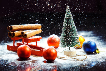 Fototapeta na wymiar Closeup image of christmas composition at falling snow backgroun