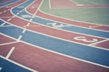 Blurred image of running track with numbers from 1 to 3. Faded color. Curves of a Running Track. 