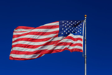 American flag waving in clear blue sky