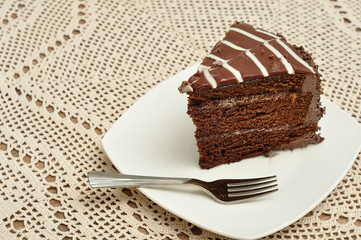 A slice of chocolate cake with a cake fork