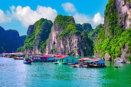 Floating fishing village rock island in Halong Bay Vietnam, Southeast Asia. UNESCO World Heritage Site. Junk boat cruise to Ha Long Bay. Landscape. Popular asian landmark famous destination of Vietnam