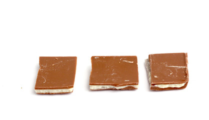 Broken yoghurt chocolate bars on white