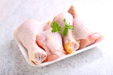 raw chicken legs in white packaging