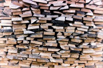 pile of cut wooden planks stacked