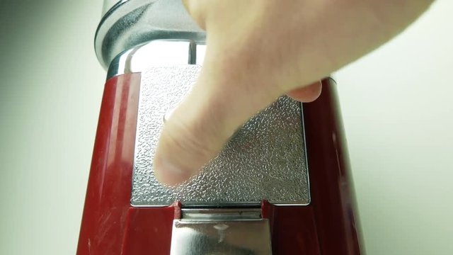 Old retro candy vending machine in use. Inserting a coin.