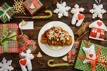 Christmas morning table with croissant and gifts. Top view