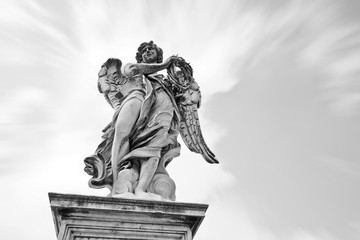 The statue of angel figure on the Aelian Bridgein in Rome in a sunny day.