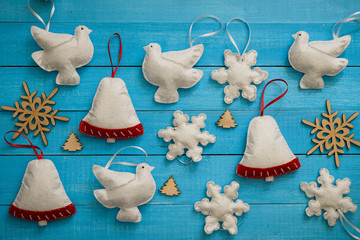 Handmade Christmas toys on the blue wooden table.
