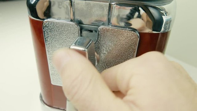 Old retro candy vending machine in use. Inserting a coin.