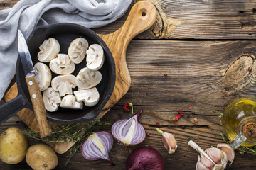 Ingredients with fresh mushrooms on wooden background