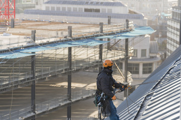 Industrial abseiler on the rooftop
