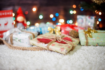 Various Christmas presents under the illuminated tree