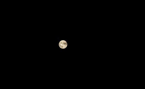 Close up of full moon on dark sky background