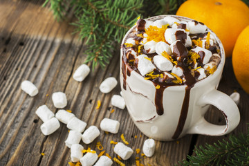 cup of hot cocoa with chocolate orange and  zest on  dark wooden background. selective focus