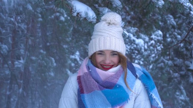 girl looks into the camera in snow forest