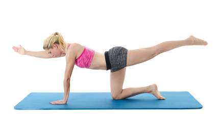 Young woman exercising on mat