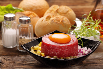 Beef tatare with egg, onion, cucumber and capers