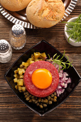 Beef tatare with egg, onion, cucumber and capers