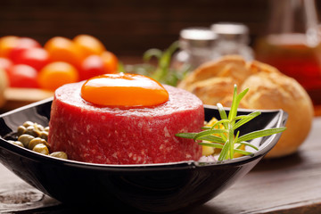 Beef tatare with egg, onion, cucumber and capers