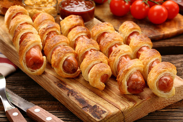 Rolled hot dog sausages baked in puff pastry