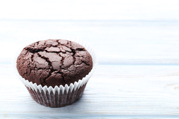 Chocolate muffin on a white wooden table