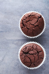Chocolate muffins on a grey wooden table