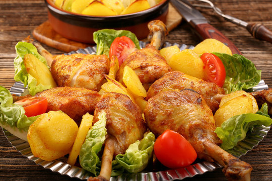 Chicken legs and baked dill potatoes with vegetable salad