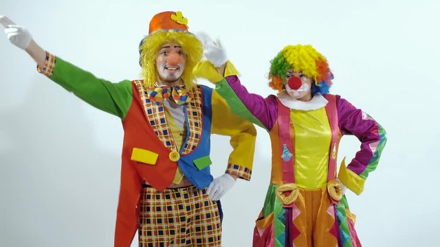 Two comic circus clowns dancing synchronously