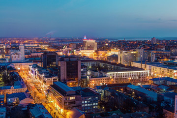 Evening cityscape from rooftop. Houses, trade centers, night lights. Voronezh 