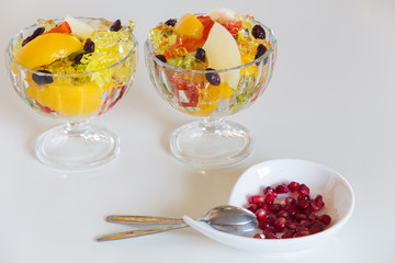 Colored dessert / sweet fruits and jelly in the bowl.
