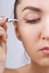 Eyelash Extension Procedure. Woman Eye with Long Eyelashes. Lashes, close up, selected focus.