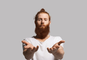 Hippy style man offer some ecological goods. Kind person with red beard and hair. Portrait of poor...