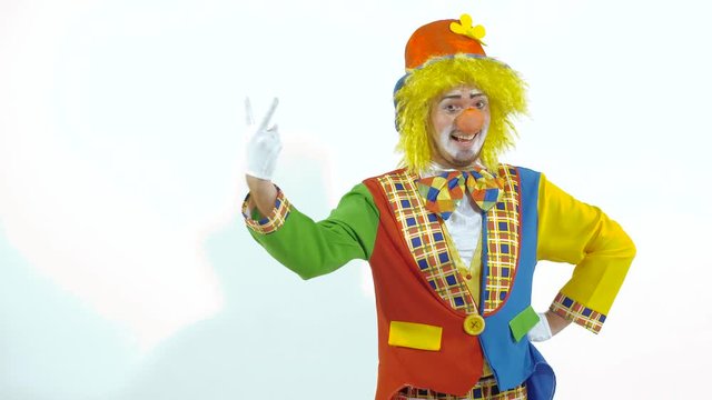Portrait of amusing colorfully dressed clown counting on his fingers