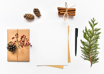 Gift box in eco paper and a letter on white background. Christmas or other holiday concept, top...