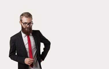 Teacher watch on students. European man in dark suit white shirt red tie look to the camera. Copy space for advertisint text or promotional content.