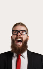 Aggressive portrait of beard person. Close up portrait of man with open mouth up look and eye glasses. Copy space for advertising text.