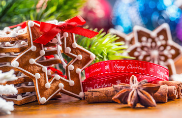 Christmas. Christmas homemade gingerbread cookies with various decorations. Red ribbon happy christmas.