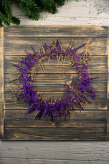 Decorative wreath designed with violet and golden decorations. Christmas and New Year time.