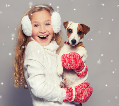 Girl in winter clothes with dog