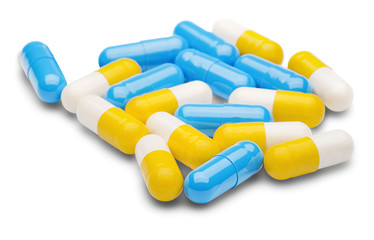 pile of medical pills and blue pills on a white background