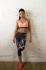  latin sport woman posing in fierce and badass face expression with fit slim body